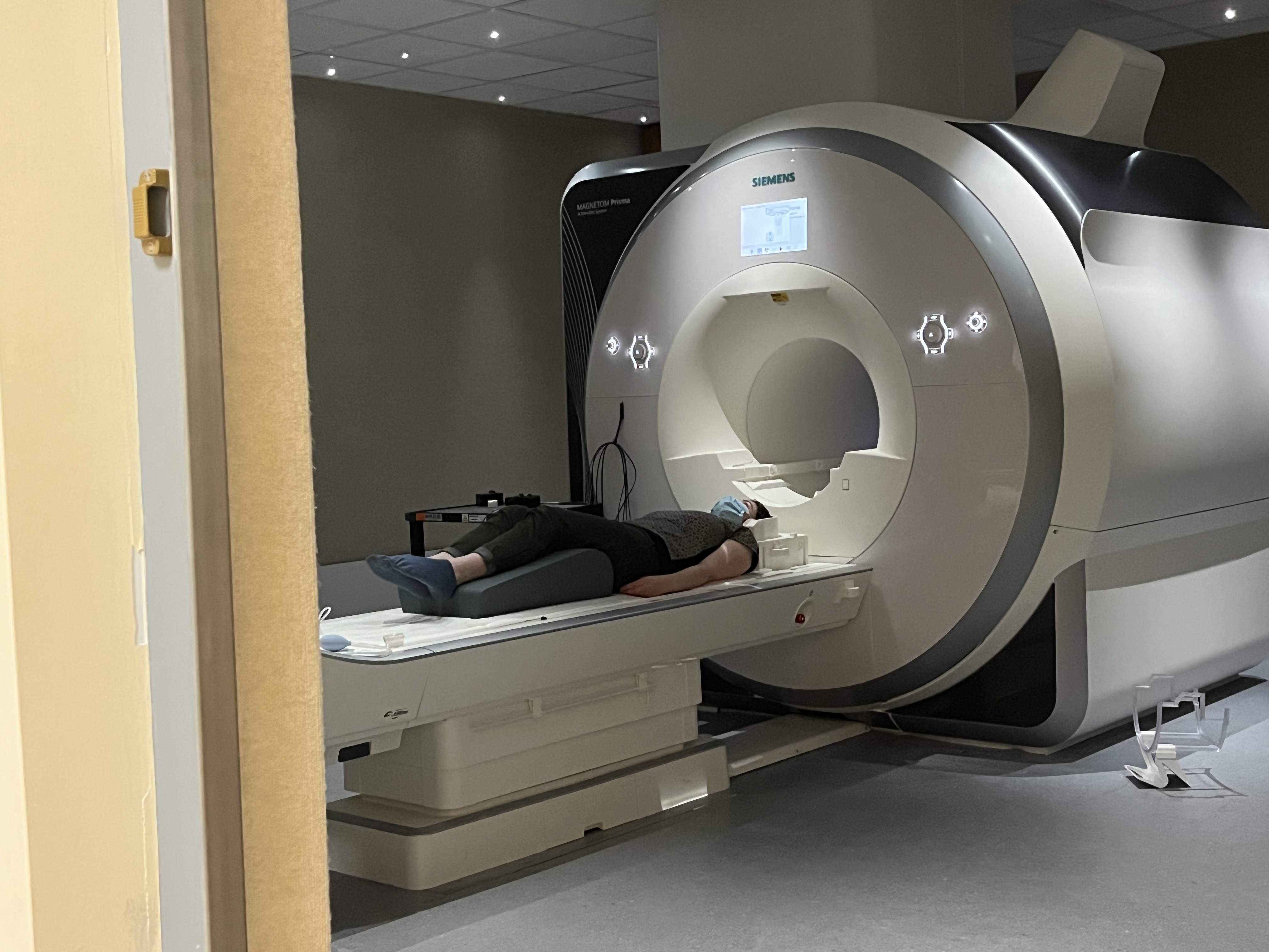 Adult woman on the scanner bed of an MRI