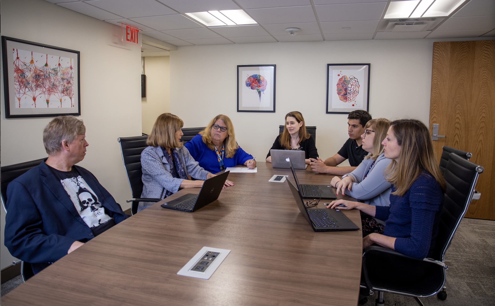 group photo of NRC staff sitting around a conference table