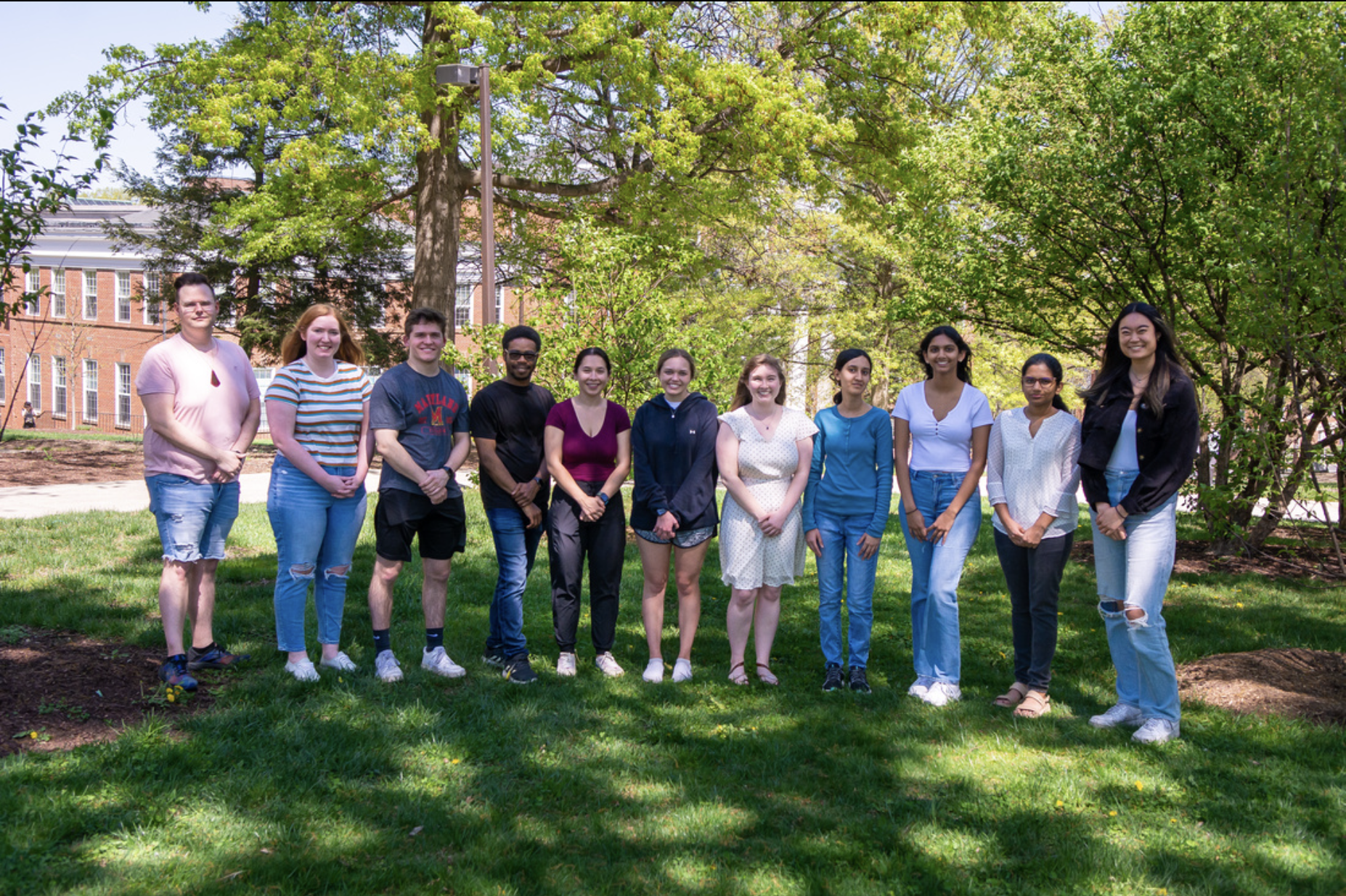 Smiling group of students standing in the grass